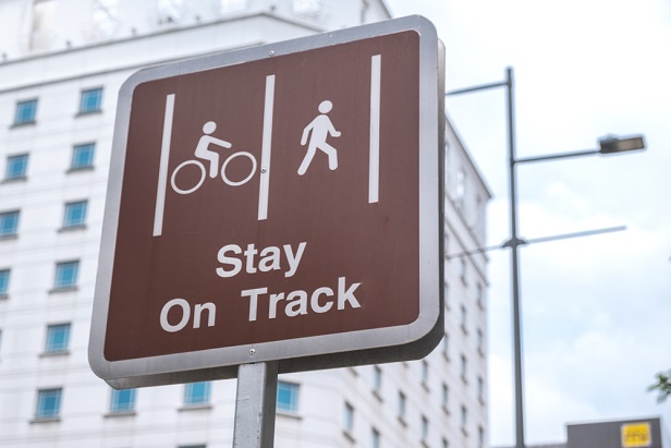 photo of sign with cyclist and walker and 'Stay on Track'