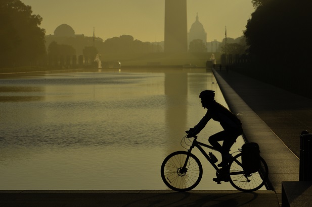 silhouetted cyclist near Washington Monument