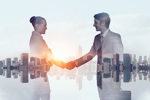 Woman and man shaking hands with background of