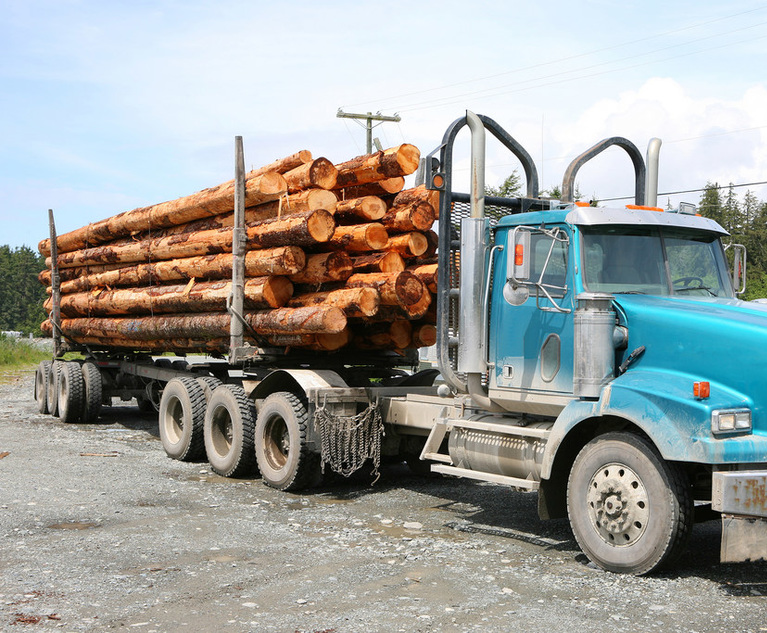 Heavy,Loaded,Logging,Truck,Parking,Next,To,A,Coastal,Road