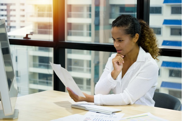 woman in office looking at papers