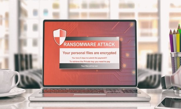 laptop with screen showing ransomware message