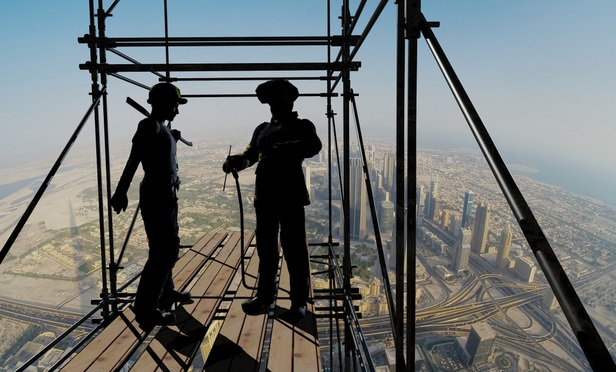 construction workers high above a city