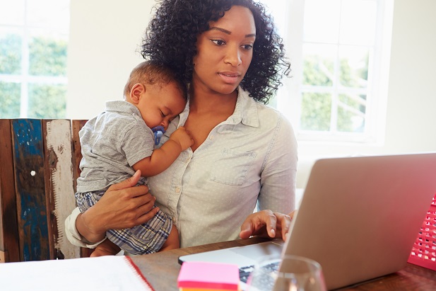 mother with infant working on computer