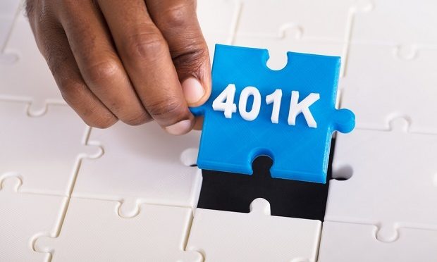 hand placing puzzle piece labeled 401k