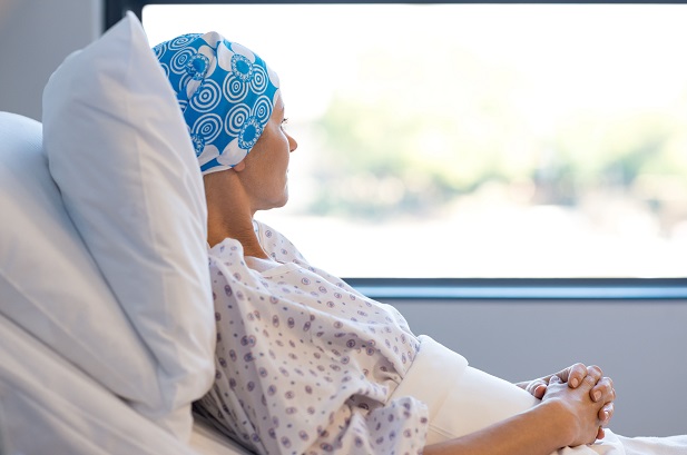 woman in hospital bed looking out window