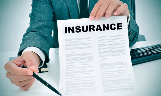 young man in suit showing an insurance policy