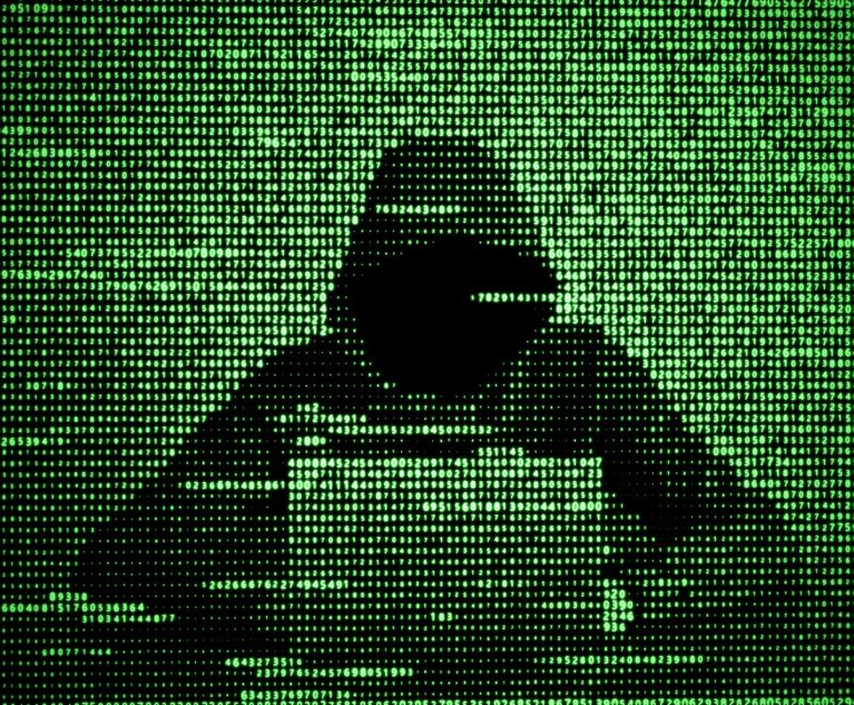 Hacker in data security concept. Hacker using laptop. Hacking the Internet. Cyber attack.