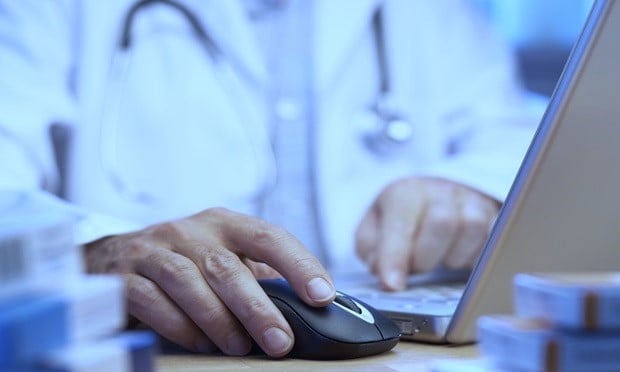 A doctor using a computer