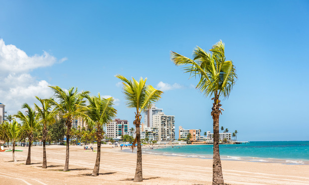 Puerto Rico San Juan beach landscape with palm trees in tropical famous tourist attraction destination in the Caribbean. Puerto Rico island, US territory.