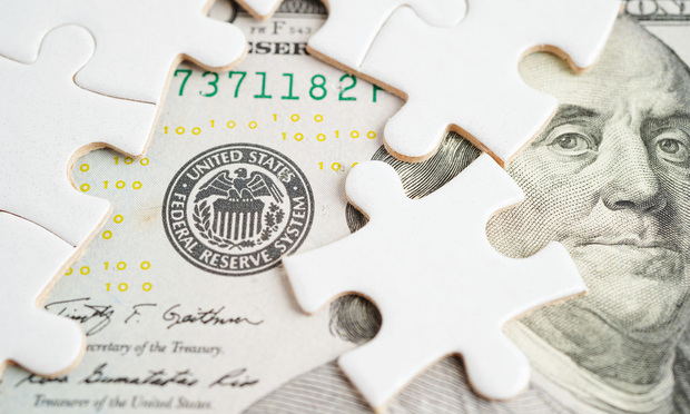 FED The Federal Reserve System with jigsaw puzzle paper, the central banking system of the United States of America.