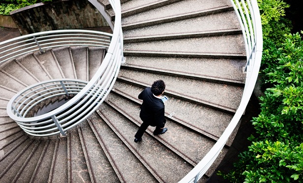 An individual walking up steps