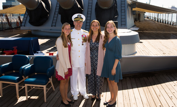 Ken Blackmon in Navy uniform standing with family