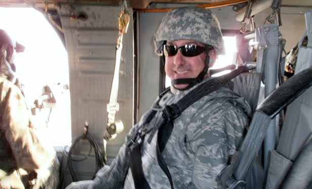 Erik Sutcliffe in Air Force uniform in a helicopter