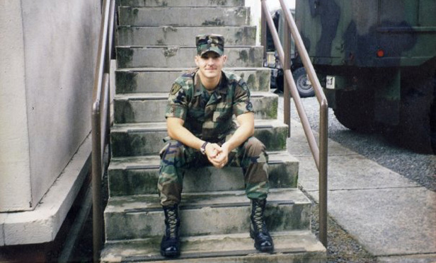 Clayton J. Winkler in Army uniform sitting on steps